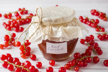 Useful currant jam in a glass jar. Fresh red currant.