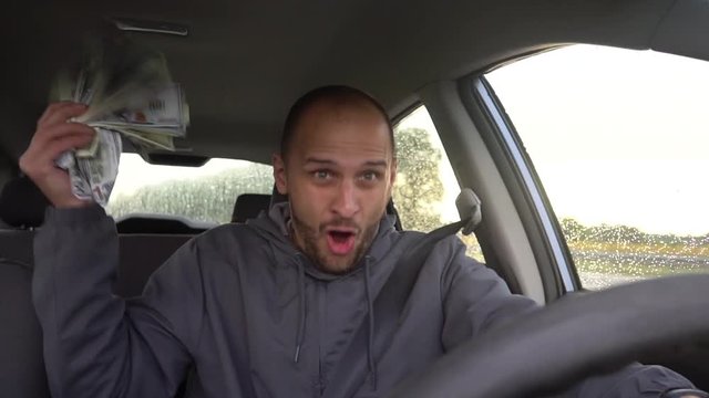 Happy driver with big money dollars. Success. Concept on the topic of lottery, winnings, slot machines, business success.