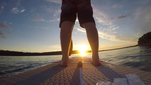 Man paddling sup at sunrise