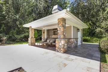 Chic outdoor kitchen space with stone columns