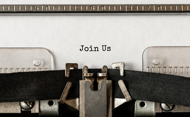 Text Join Us typed on retro typewriter