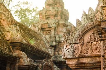Naklejka premium Carved stone decors on Bantai Srei buddhist temple's roofs in Angkor Wat park, Cambodia