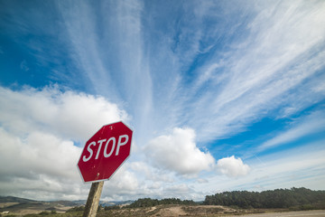 Stop sign under a cloudy sky in Central California
