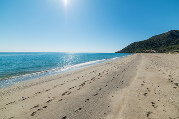 Sun shining over Perdepera beach on a summer day
