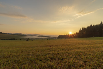 Summer landscape while sunrise in the Czech Republic near the National park of Sumava.