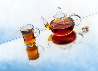 tea pot with tea and cup