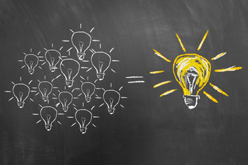 Brainstorming concept with light bulb on chalkboard or blackboard.