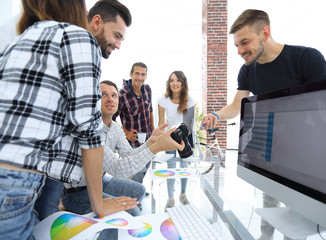 group photo of editors working in a modern office.