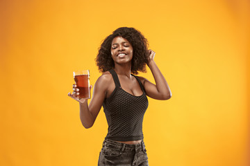Sexy young afro woman drinking beer, not isolated on white background