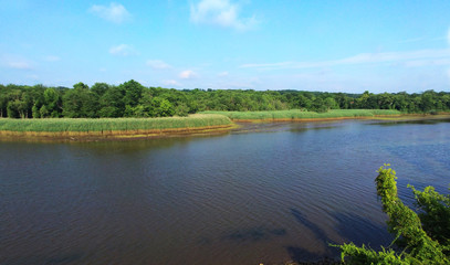 Island view from the height, the river and the forest at sunset