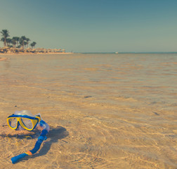 Fototapeta na wymiar diving tube and mask in sea water at coast background