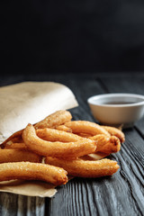 homemade  churros on dark table