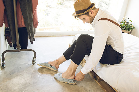 Man Putting His Shoes On At Home .