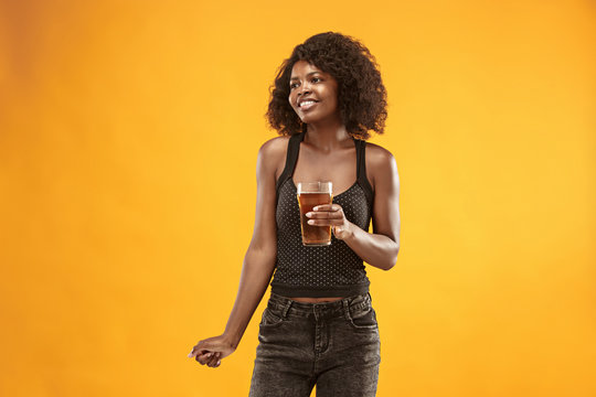 Sexy young afro woman drinking beer, not isolated on white background