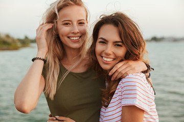 Fototapeta na wymiar Women friends hugging outdoors on the beach.