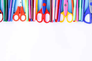 School supplies. Back to School design elements. Colorful markers and scissors on white paper background.