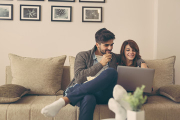 Couple reading news on laptop