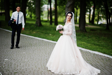 Wedding couple walking and enjoying themselves in the park on a beautiful day.