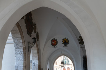 Symbols above the arcs on Market Square in Krakow