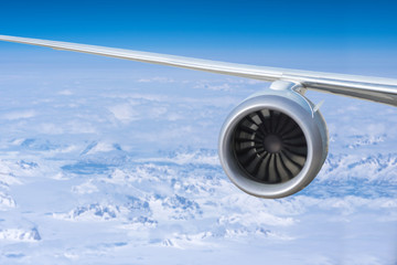 airplane engine above the Greenland with ocean and glaciers