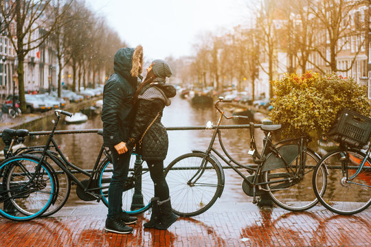 guy and girl in the street in the rain