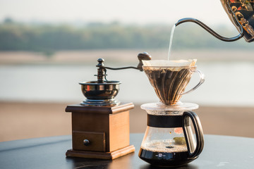 Pouring drip coffee with kettle