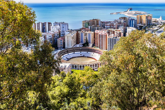 Beautiful aerial view on the Malaga with Plaza de Toros (Bullring, 1874) from Gibralfaro Castle on a sunny day. Malaga, Costa del Sol, Andalusia, Spain.