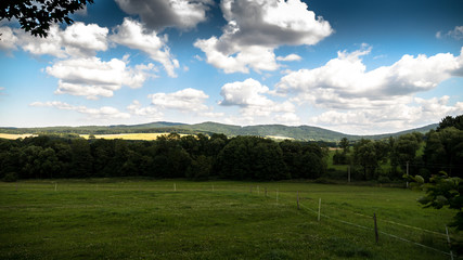 Fototapeta na wymiar Summer countryside landscape with clouds