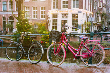 Fototapeta na wymiar Bicycles lining a bridge over the canals of Amsterdam
