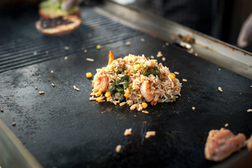 The process of cooking rice with vegetables. Asian cuisine. Street food.