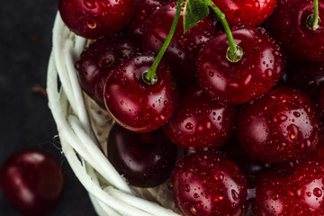 Red, ripe cherries closeup on a dark background