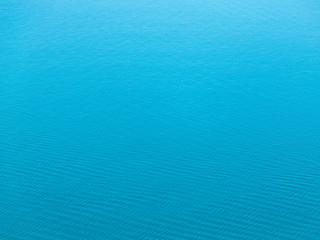 Sea texture of the water surface with slight ripples in sunny day. Bird's eye view.