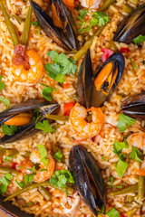 paella with seafood and vegetables close-up