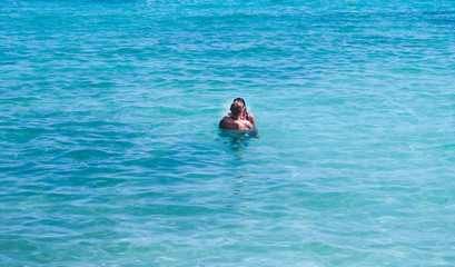 Two adults kissing at Balearic sea of Menorca