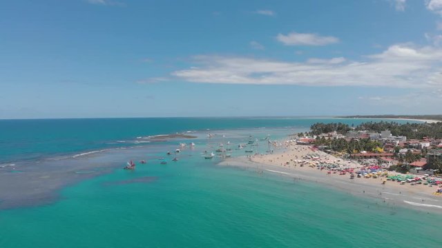 wide drone shot of blue sea on the beach in brazil, porto de galinhas