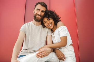 low angle view of happy young multiracial couple laughing together