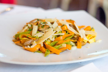 Spaghetti with cheese and mushrooms. Spaghetti with colorful pasta.