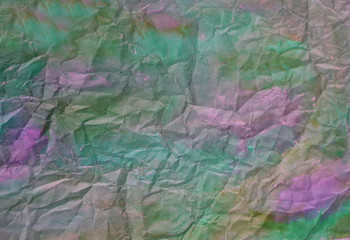 beautiful abstract colorful background with shades of green and purple, hand-painted watercolor on rumpled paper