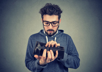 man with no money holding an empty wallet