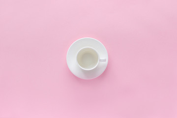empty white coffee cup and dish saucer on pink background