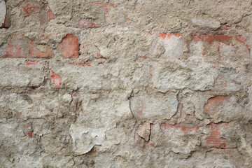 Closeup of weathered old damaged wall, bricks and mortar