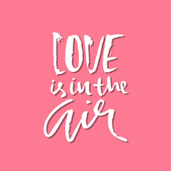 Love is in the air. Handdrawn calligraphy for Valentine day. Ink pink illustration. Modern dry brush lettering. Vector illustration.