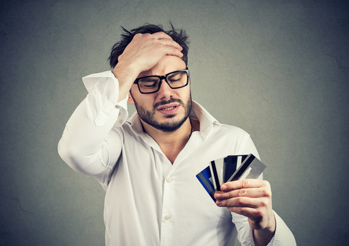 Stressed man having debts with credit card