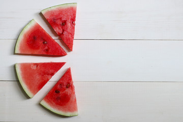 sliced watermelon on wood tip view  summer background