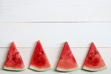sliced watermelon on wood. summer backround many pieces of watermelon