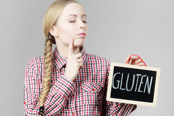 Woman holding board with gluten sign