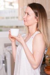 Portrait of cheerful female who is playful posing with tea