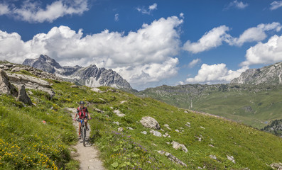 active senior woman, riding her e-mountainbike in the Arlberg area near Lech,Tirol,Austria