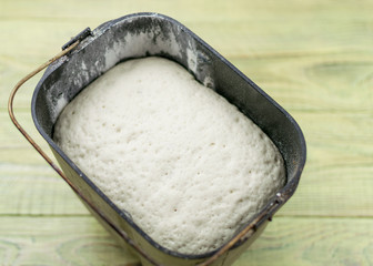 Raw dough for bread in the form of a breadmaker. Preparation of bread in the bakery.