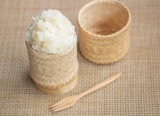 selective focus sticky rice in bamboo wicker with wooden fork